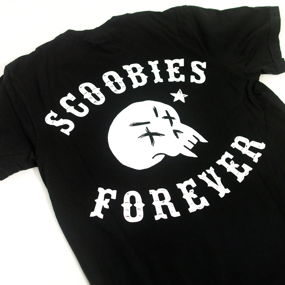 close up, angled image of the back of a black tee shirt on a white backgroun.d back of tee has print in white of a vampire skull. above the skull says scoobies. below the skull says forever