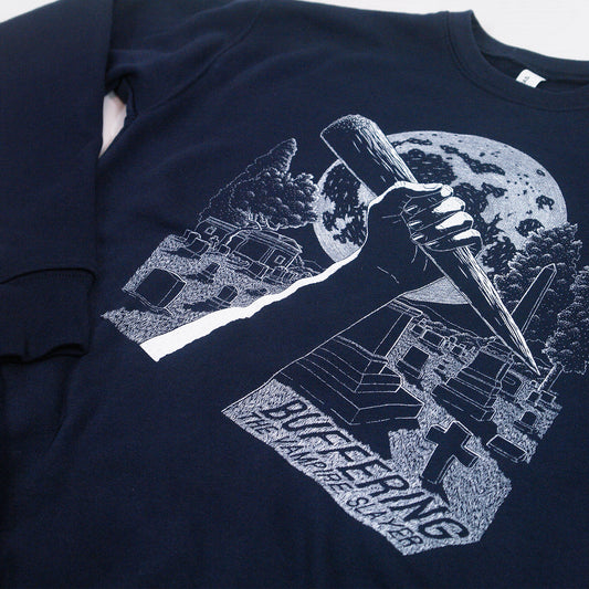 close up angled image of a navy crewneck sweatshirt on a white background. crewneck has a white print on the center chest of a hand holding a stake in a cemetary over a full moon. bottom left says buffering the vampire slayer
