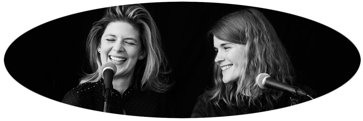 oval image in black and white of two happy women who host the podcast 