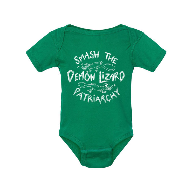 A Kelly Green baby onesie by Buffering the Vampire Slayer with white text saying “Smash the Demon Lizard Patriarchy” and simple lizard illustrations around the words.