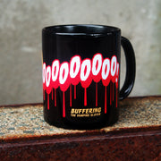 image of a black coffee mug. mug has full print in white and red that says AWOOOOOO! on the bottom says buffering the vampire slayer.