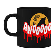 image of a black coffee mug on a white background. mug has full print in white and red that says AWOOOOOO! Above is an orange moon with a black Silhouette of a warewolf and the words until next time.