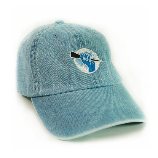 image of a denim dad hat on a white background. hat has small embroidery on the front of a circle, with a hand holding a stake