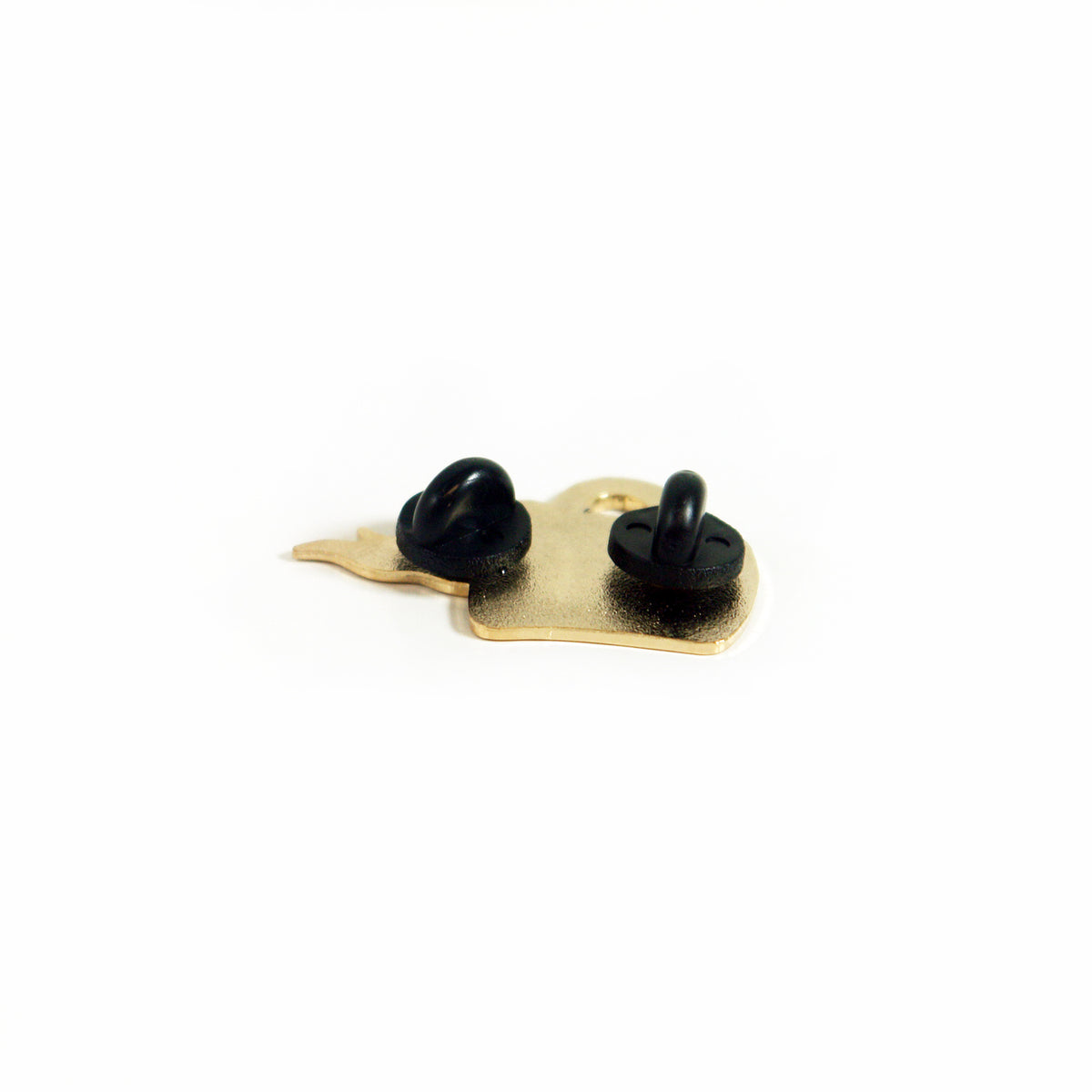 A gold enamel pin by Buffering the Vampire Slayer is shown from the back, displaying two black rubber clutch fasteners on a white background.