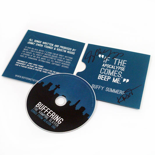 image of the inside of a gatefold CD case. CD is on the left and laying over the signed inside