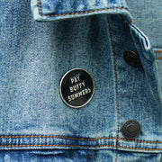 image of an enamel pin, pinned on a jean jacket. pin is circle and says pay buffy summers